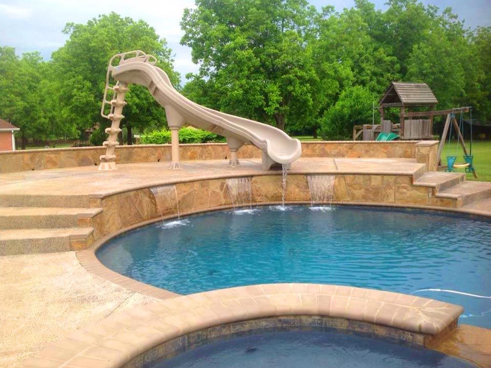 in-ground pool with water slide