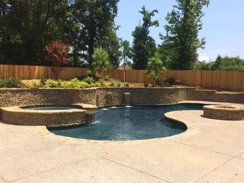 custom pool with natural stone wall