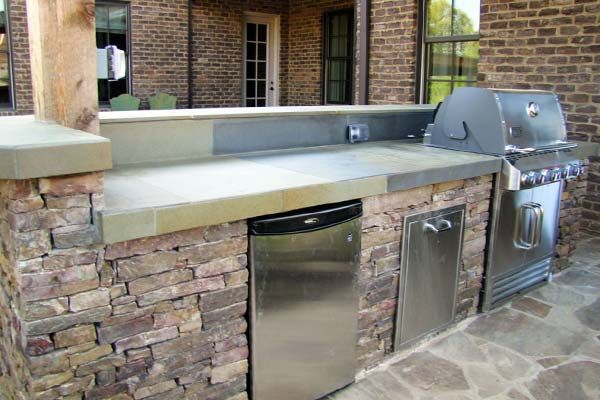 outdoor kitchen with natural stone